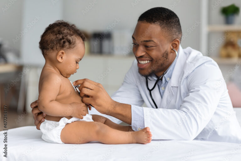 Black Pediatrician Doctor Doing Check Up To Cute Newborn Baby In Diaper 